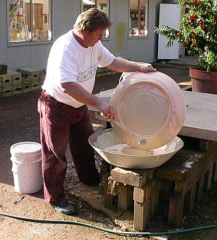 Paul Davis glazing a platter